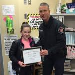 Islander Middle School student Caroline Crow receives her award from MIFD Lt. Ray Austin. Photo courtesy of Ray Austin