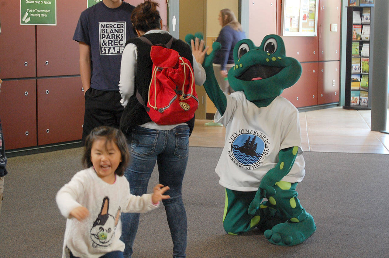 Leap, the sustainability fair&rsquo;s frog mascot, meets Islanders at the Community and Event Center. Katie Metzger/file photo