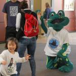 Leap, the sustainability fair&rsquo;s frog mascot, meets Islanders at the Community and Event Center. Katie Metzger/file photo