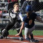 Photo courtesy of Jim Nicholson                                Mercer Island Islanders catcher Kayla Varney tags out a Bellevue runner at the plate in a battle between KingCo 3A rival squads. The Islanders defeated the Wolverines 12-11 on March 29.