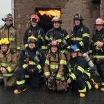 The training group poses after an exercise involving entering a burning building. Photo via Twitter