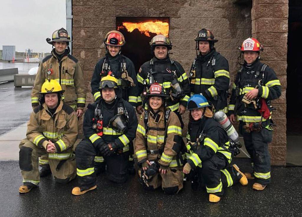 The training group poses after an exercise involving entering a burning building. Photo via Twitter