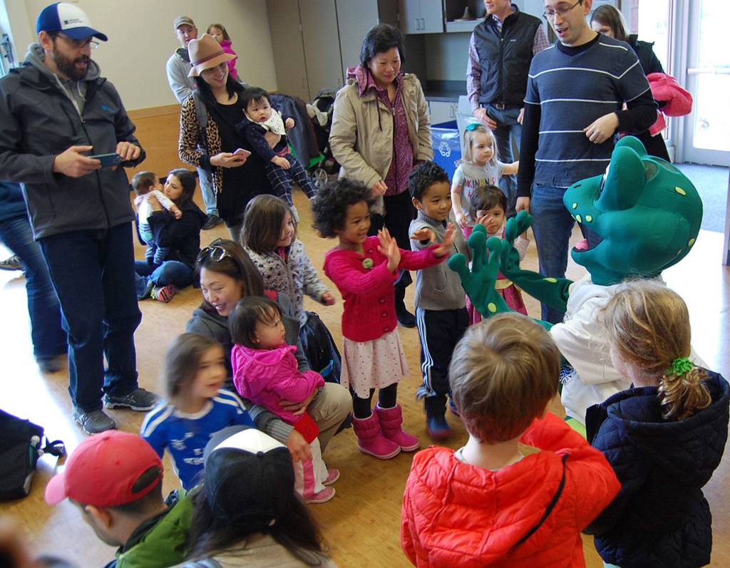 Leap, the fair&rsquo;s frog mascot, meets children and families at Saturday&rsquo;s sustainability fair. Katie Metzger/staff photo