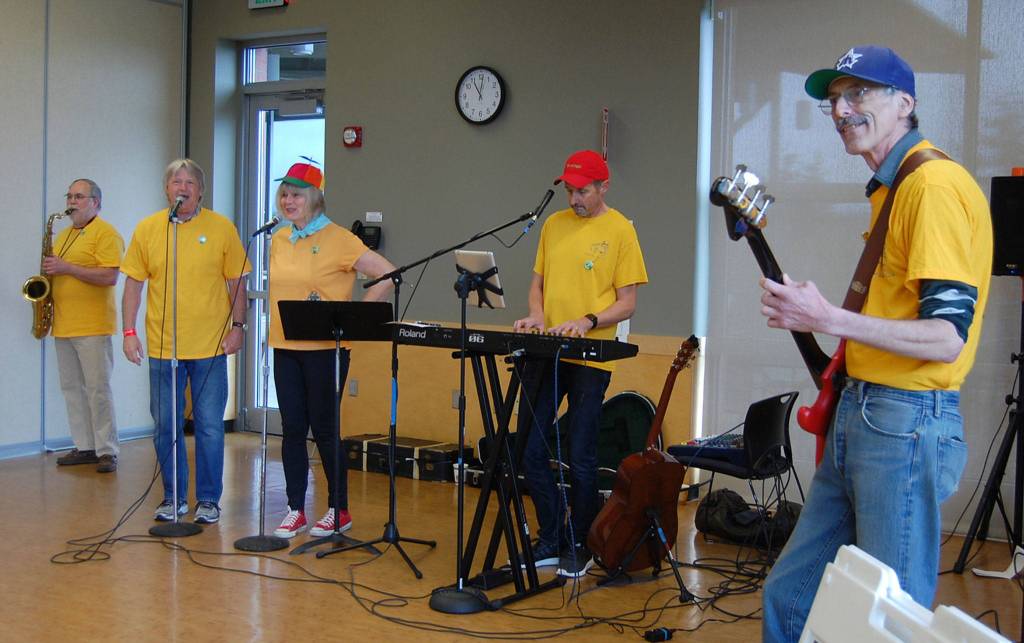 The Bus Boys, a band compromised of bus drivers for the Mercer Island School District, performs at the Leap for Green fair. &ldquo;Riding a school bus is a great way to go green,&rdquo; they said. Katie Metzger/staff photo