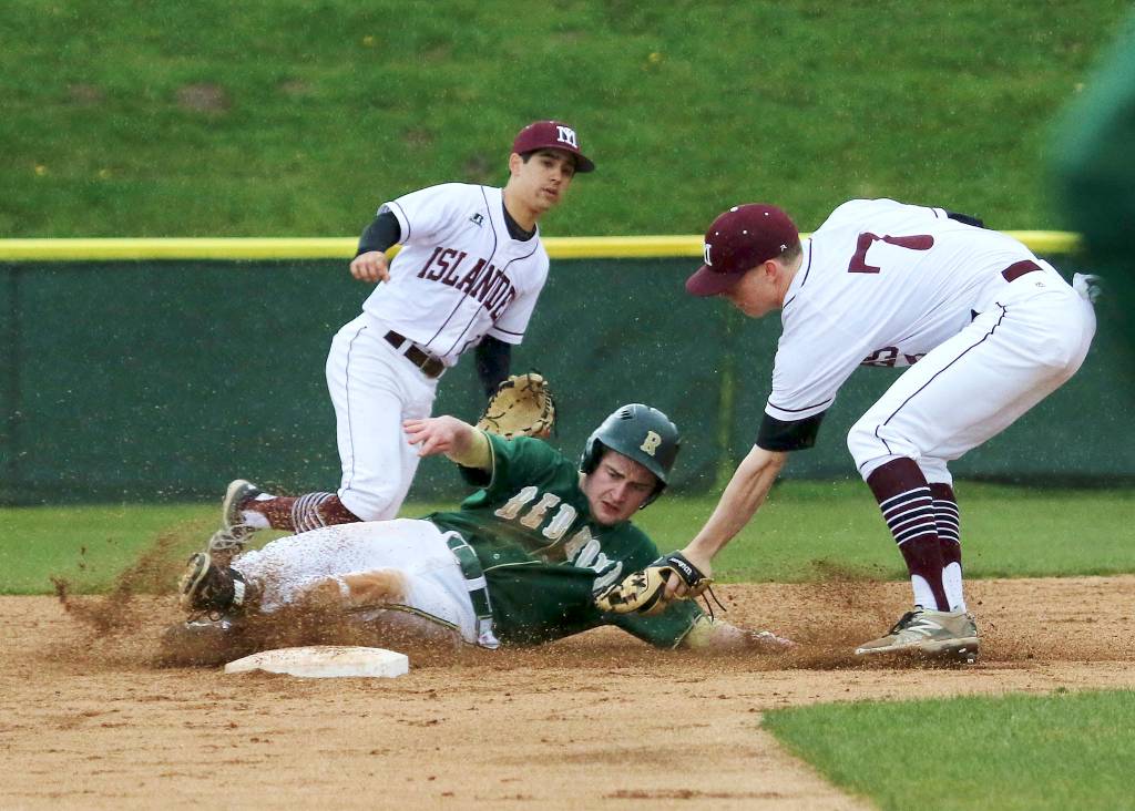 Photo courtesy of Jim Nicholson                                Mercer Island infielder Jack Smith, right, tags out a Redmond runner at second base. Mercer Island pounded out 12 hits in the win against Redmond on April 26.