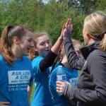 Mercer Island&rsquo;s Recreation Superintendent Diane Mortenson high fives finishers of the Run Like a Girl 5K on May 13. Katie Metzger/staff photo