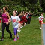The Eastside Dream Elite team cheers on Run Like a Girl finishers on May 13. Katie Metzger/staff photo