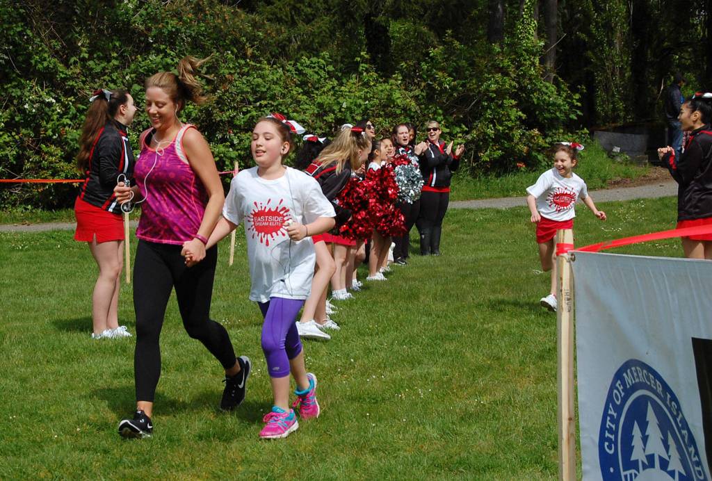 The Eastside Dream Elite team cheers on Run Like a Girl finishers on May 13. Katie Metzger/staff photo