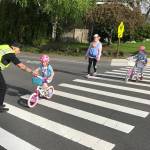 Officer Scott Hyderkhan greets riders as they make their way to school. Photo courtesy of MIPD