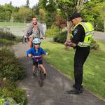 Mercer Island police officer Scott Hyderkhan helps kids get to West Mercer Elementary safely for Bike to School Day on May 10. Photo courtesy of MIPD