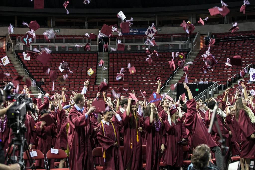 Mercer Island High School graduates toss their caps in the air. Photo courtesy of David Cummings