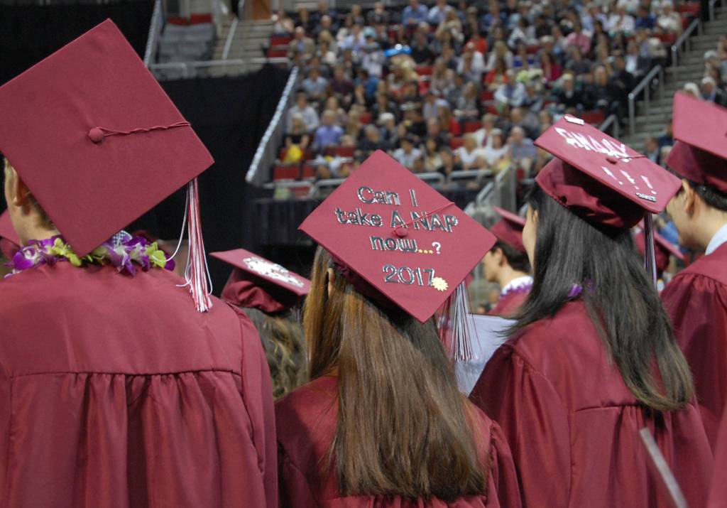 MIHS students face the stage during graduation, displaying their decorated caps. Katie Metzger/staff photo