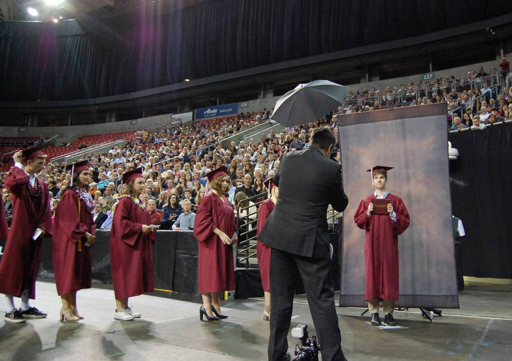 Students get their pictures taken before receiving their diplomas on stage at KeyArena. Katie Metzger/staff photo
