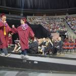 MIHS grads give each other a fist bump after receiving their diplomas. Katie Metzger/staff photo