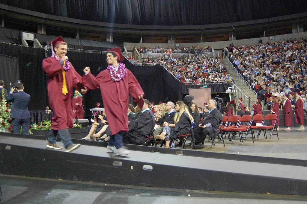 MIHS grads give each other a fist bump after receiving their diplomas. Katie Metzger/staff photo