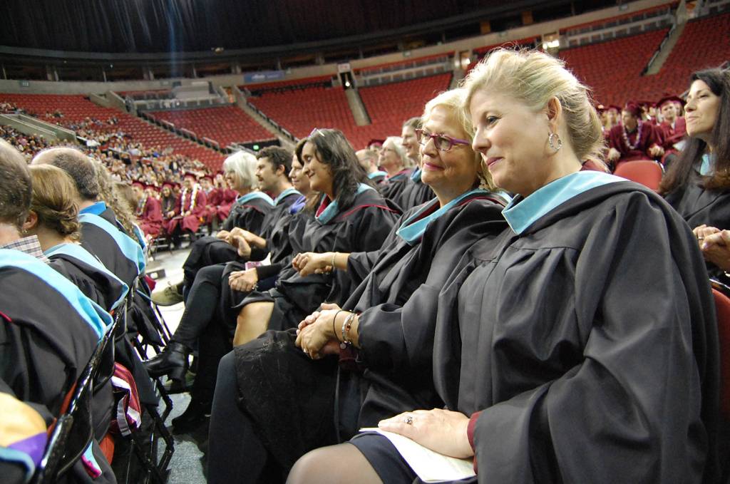 MIHS teachers hold hands during Chris Twombley&rsquo;s speech. Katie Metzger/staff photo