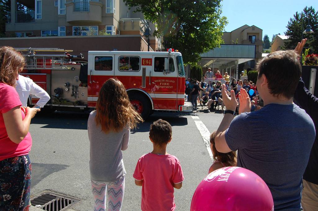 Islanders applaud the Mercer Island Fire Department at the end of the Summer Celebration parade. Katie Metzger/staff photo