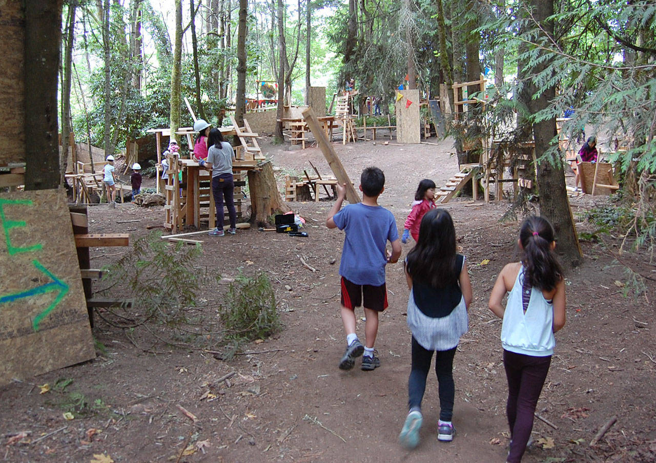 Adventure Playground has taken shape, with families, summer campers, city staff members and volunteers contributing to the village of wooden structures in Deane&rsquo;s Children&rsquo;s Park since it opened in June. Katie Metzger/staff photos