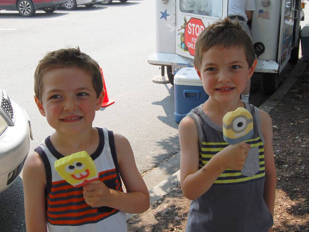 Cooper and Jackson, of Kent, eat ice cream while they wait for the Blue Angels practice to begin. Katie Metzger/staff photo