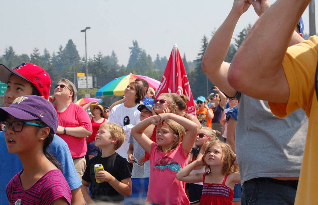 Kids cover their ears as planes whiz by the I-90 bridge during Seafair. Katie Metzger/staff photo