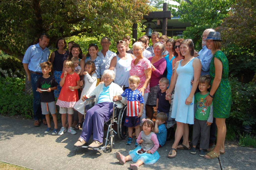 Ruth Mary Close and her family gather for a photo in front of Emmanuel Episcopal&rsquo;s mission bell. Close carved the inscription on the bell. Katie Metzger/staff photo