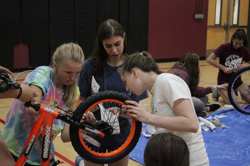 MIHS girls’ volleyball team bonds by building bikes