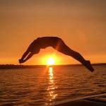 Islander Brooke Andrews dives into Lake Washington. Photo courtesy of Dawn Bova