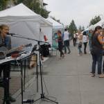 Mercer Island High School senior Sophie Feldman entertains the crowd at Art Uncorked as they make their way from &ldquo;Art Alley&rdquo; along 78th Avenue Southeast to the wine and beer garden in the Greta Hackett Outdoor Sculpture Gallery. Katie Metzger/staff photos