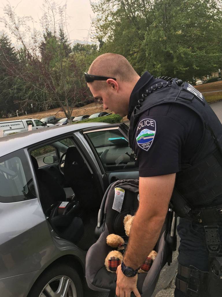 Officer Chase Hawley helps an Islander with questions about car seat safety. Father-to-be Trevor Wong had questions about installing and using a car seat in his vehicle. Photo courtesy of MIPD