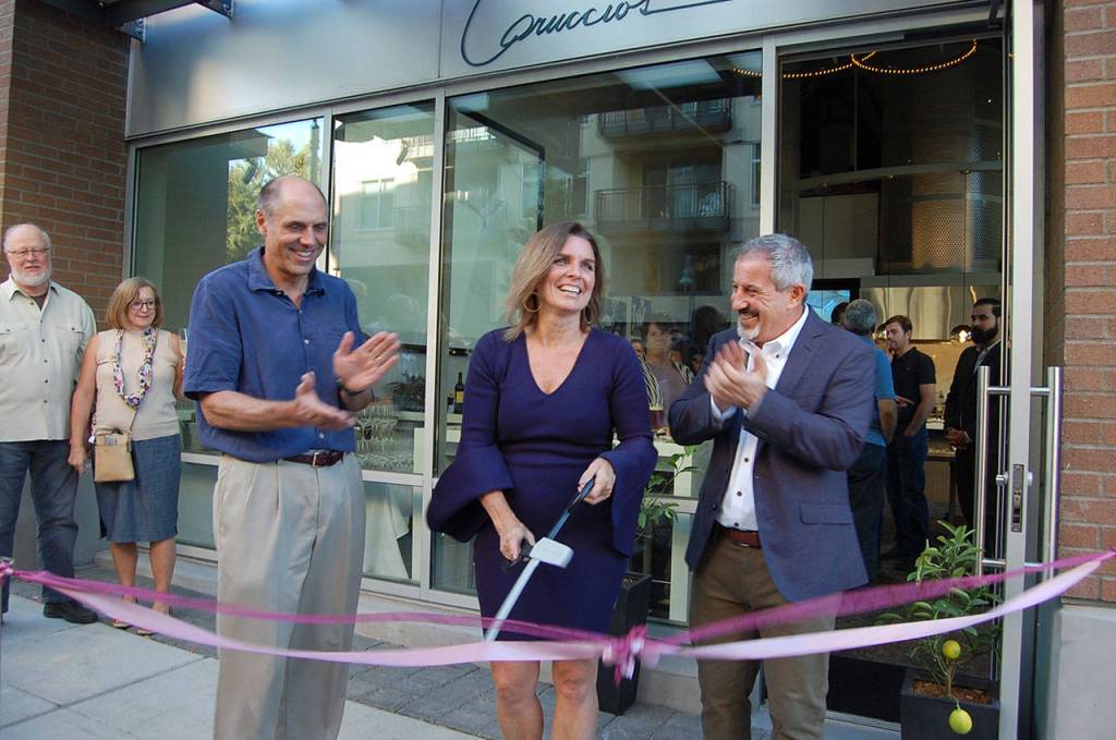 Mercer Island Mayor Bruce Bassett and Lisa and Rino Caruccio celebrate the opening of a new Mercer Island business, Caruccio&rsquo;s, on Sept. 14. Katie Metzger/staff photo