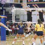 Photo courtesy of Jim Nicholson                                Mercer Island junior Tessa Fisk, left, and Quinn Casey, right, leap for the ball against the Bellevue Wolverines in a matchup between KingCo 3A powerhouses on Sept. 20 at Bellevue High School. Mercer Island defeated Bellevue 3-1 (25-23, 26-24, 17-25, 25-21).