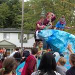 Students on the senior float throw necklaces and candy into the Homecoming Parade crowd. Katie Metzger/staff photo