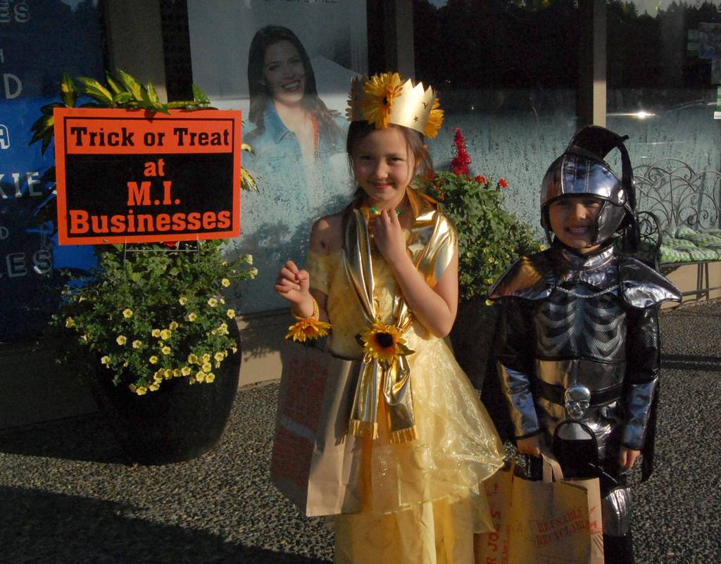 Kite and Cal Robinson, ages 7 and 6, trick or treat in Islandia Center on Halloween. Katie Metzger/staff photo