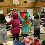 During parent conferences last week, volunteers set up a dozen tables loaded with donated clothes in the gym of Evergreen Heights Elementary in Auburn. Families were invited to browse the selection and take what they need. Photo courtesy of the Auburn School District