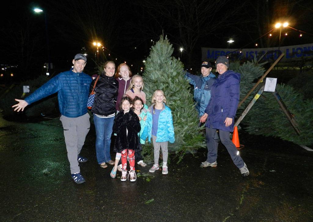 The Whelan family (parents Scott and Shelley with their children Austin, Lindsay and Reagan and friends Charlotte and Mia Weil) poses after buying their holiday tree at the Mercer Island Youth and Family Services Foundation and Lions Club tree lot. The lot opened Saturday and will sell trees Thursday through Sunday until Dec. 22. Photo courtesy of Cindy Goodwin