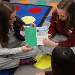 MIHS students read a book about a cactus family to a third grader at Northwood. Katie Metzger/staff photo