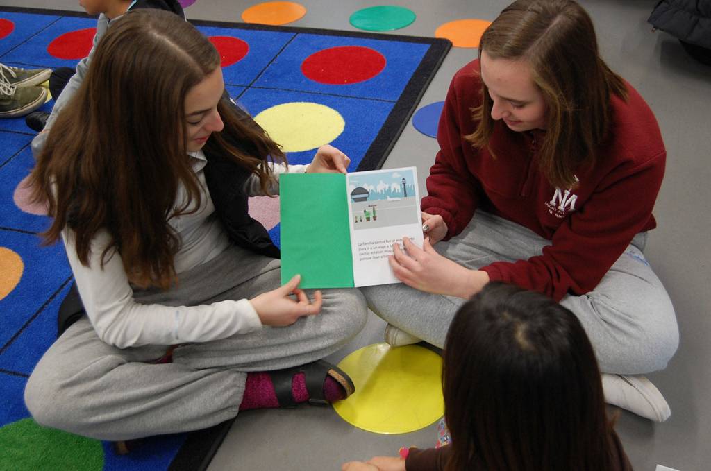 MIHS students read a book about a cactus family to a third grader at Northwood. Katie Metzger/staff photo