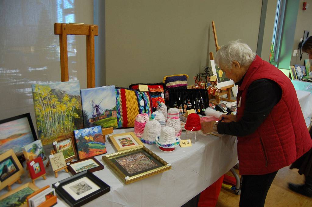 The meeting room in the Mercer Island Community and Event Center was lined with tables of handmade art pieces and gifts on Dec. 7. Katie Metzger/staff photo