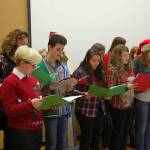 MIHS students dress in festive sweaters to perform for chamber members. Katie Metzger/staff photo