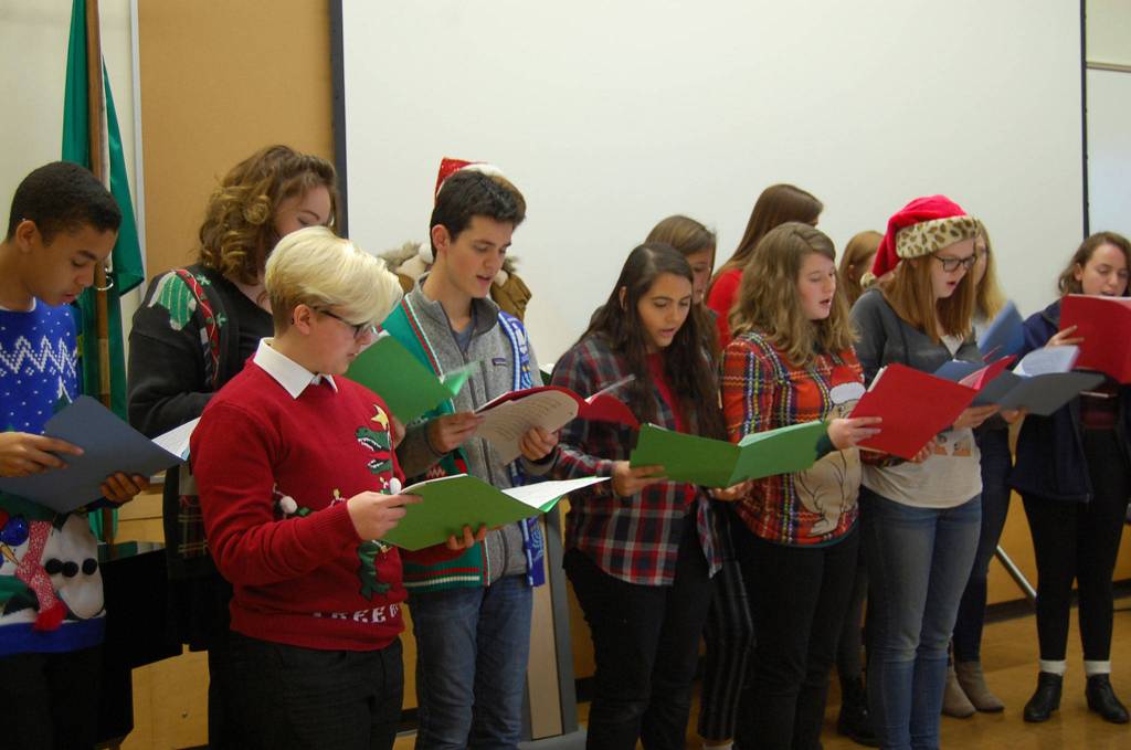 MIHS students dress in festive sweaters to perform for chamber members. Katie Metzger/staff photo