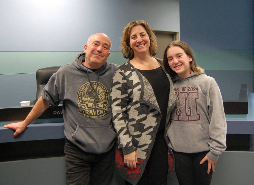Deborah Schneider Lurie smiles with her family after being sworn in to serve Mercer Islanders on the School Board. Katie Metzger/staff photo