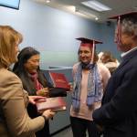 Superintendent Donna Colosky and Mercer Island High School Principal Vicki Puckett give retiring school board members Adair Dingle and Dave Myerson caps and honorary diplomas on Dec. 14. Katie Metzger/staff photo