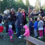Community members admire the new peace pole in the garden at the Stroum Jewish Community Center after its installation on Dec. 20. Katie Metzger/staff photo