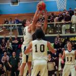 Photo courtesy of Don Borin/Stop Action Photography                                Mercer Island senior forward Giovanni Cervantes-Rocha, center, secures a rebound against the Bellevue Wolverines on Jan. 3. Bellevue defeated Mercer Island 61-57 in a matchup between rivals.