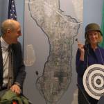 Former Mayor Bruce Bassett gifts Debbie Bertlin with a bulls-eye, helmet and gavel at the Jan. 9 Mercer Island City Council meeting, after Berlin was selected as the new mayor. Katie Metzger/staff photo