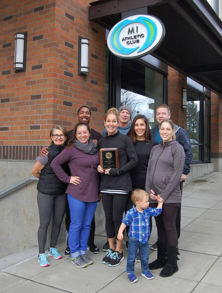 Ginny Pietila and some MI Athletic Club staff members (and Jake) pose outside the gym, located in downtown Mercer Island. Katie Metzger/staff photo