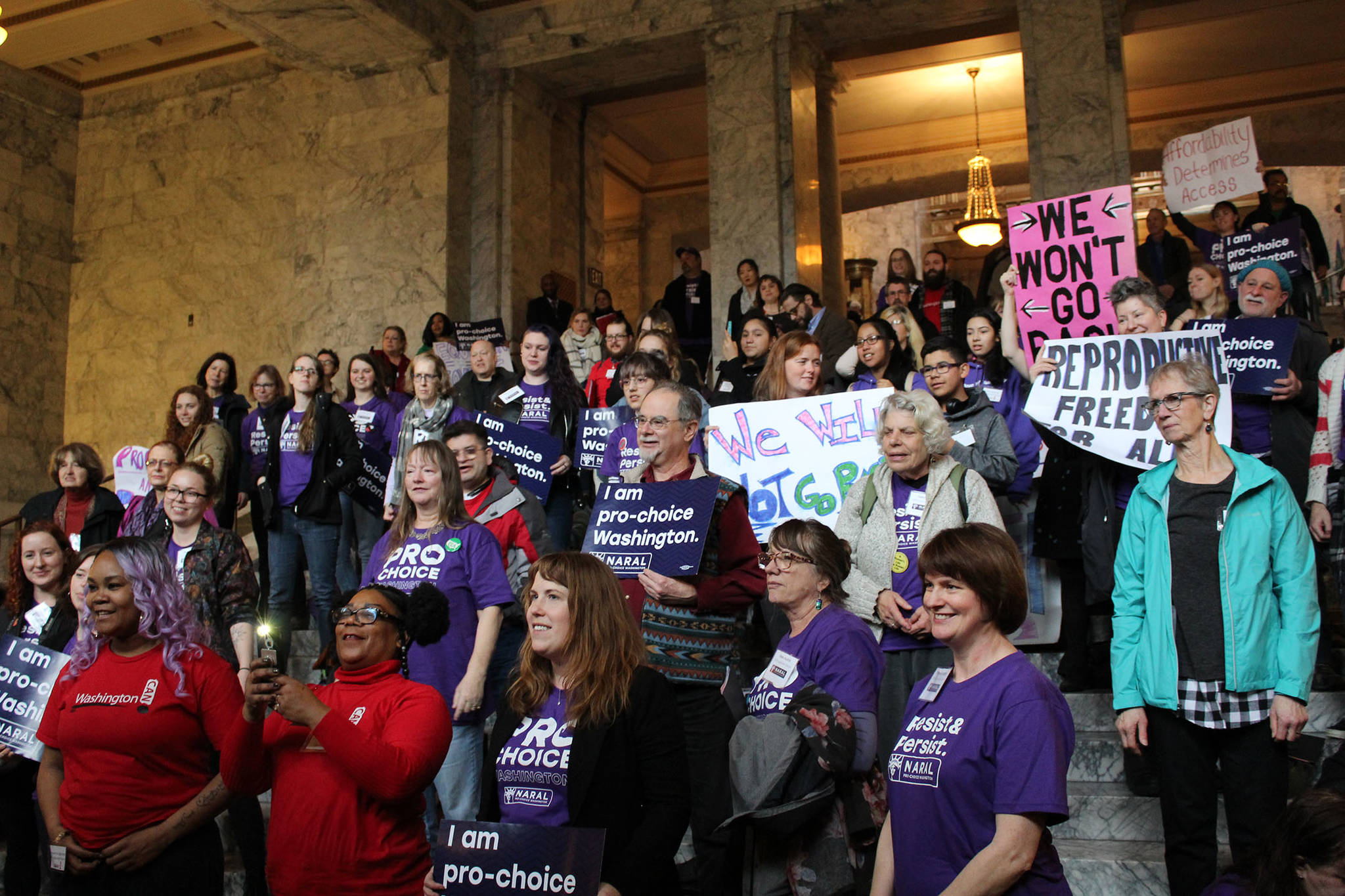 Nearly 100 people gathered in the Capitol Legislative Building in Olympia on Thursday, Jan. 18, to rally in support of the Reproductive Parity Act and other womens health bills. Photo by Taylor McAvoy