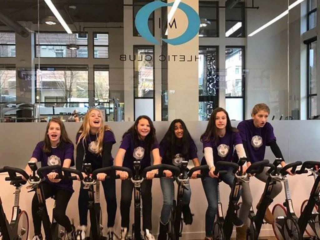 Volunteers pose on equipment at MI Athletic Club, which is participating in Shop and Dine Local on Feb. 7-8. Photo courtesy of MIYFS Foundation