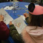Audience members at Disney and Dessert color pages featuring Goofy, Donald Duck and Simba while waiting for the concert to start. Katie Metzger/staff photo