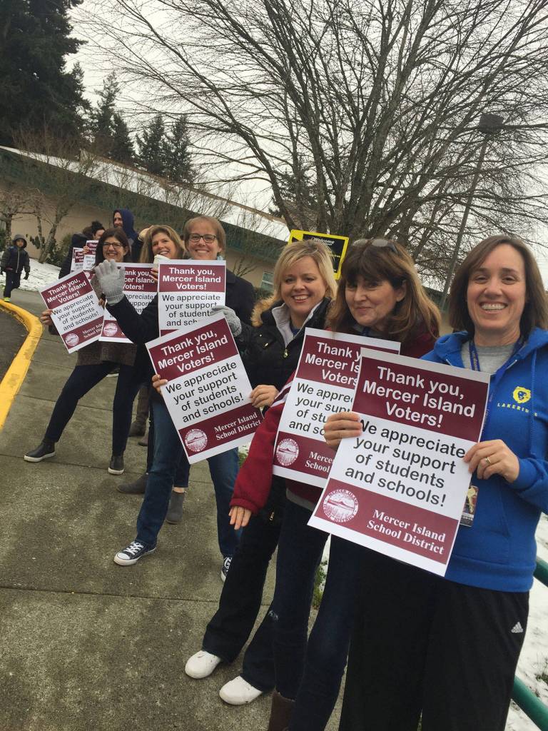 Staff across the Mercer Island School District, including this group from Lakeridge Elementary, held signs on Feb. 23 to thank voters for their support of the Replacement Educational Maintenance and Operations Levy in the recent special election. The levy passed with 71 percent in favor, the highest approval rate for any school ballot measure in King County. Courtesy of MISD